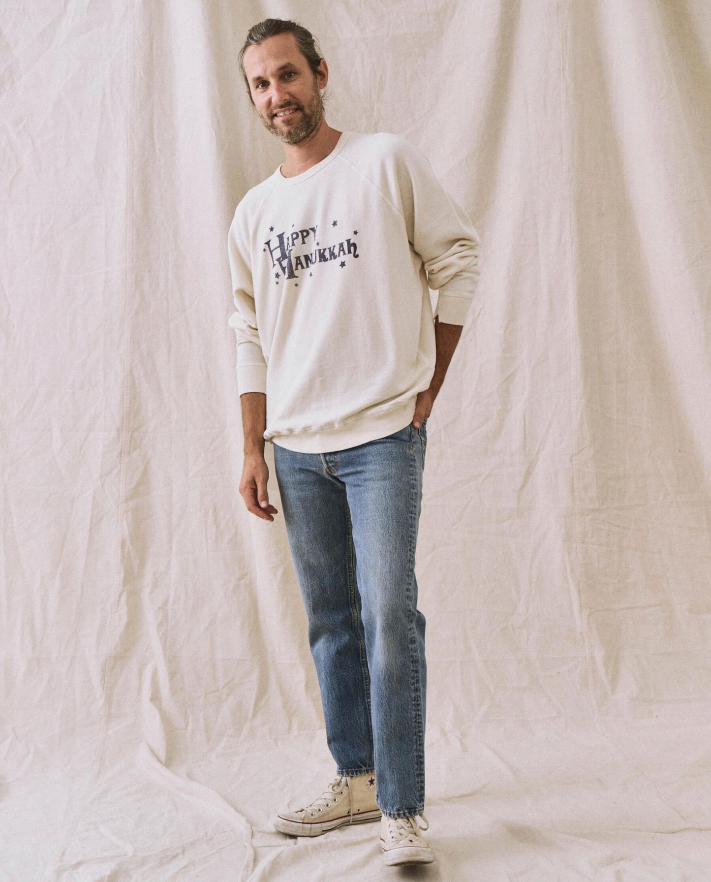 The Men's College Sweatshirt. -- Washed White with Hanukkah Graphic